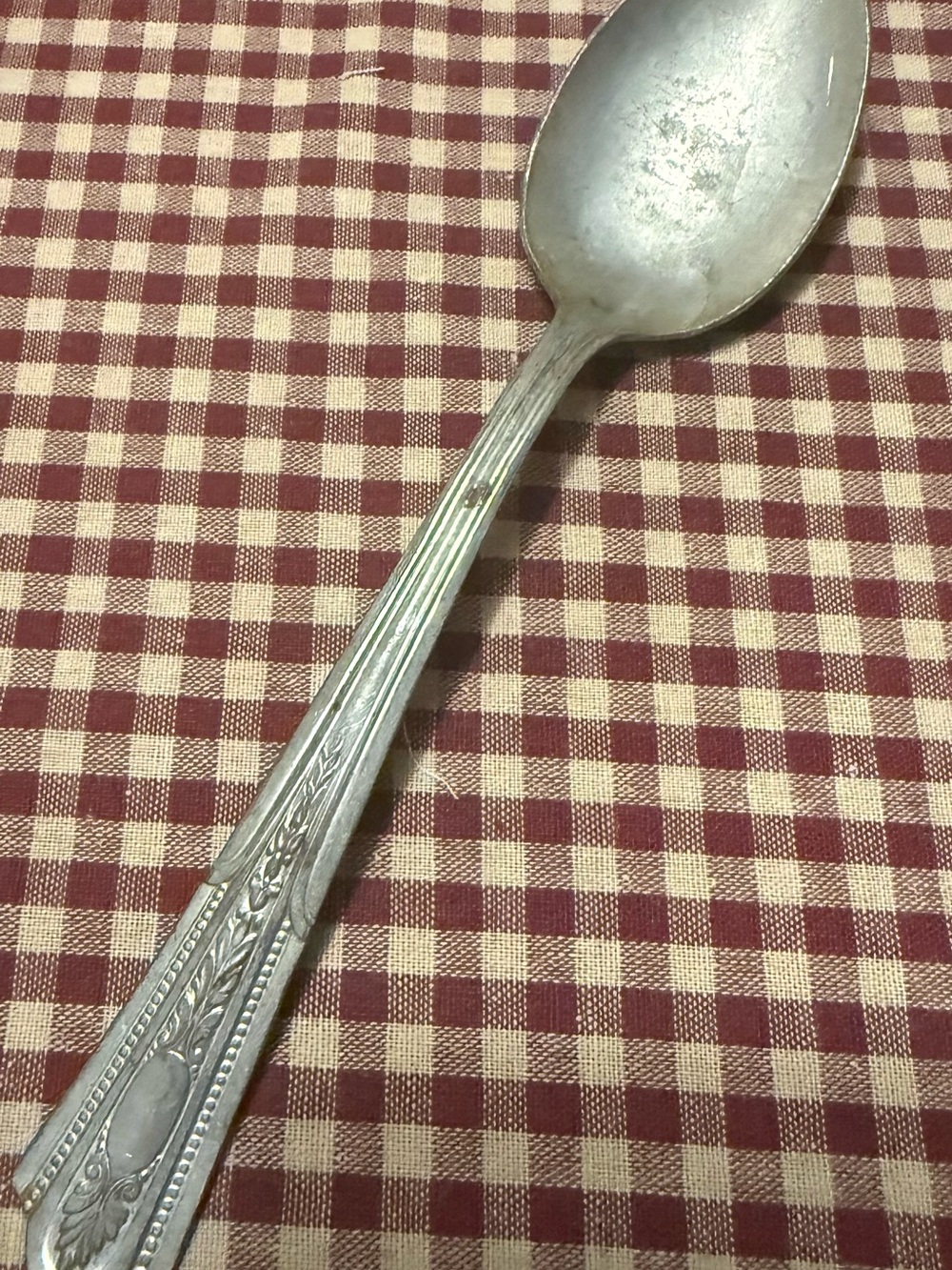 Decorative Silver-Tone Serving Spoon with Ornate Handle